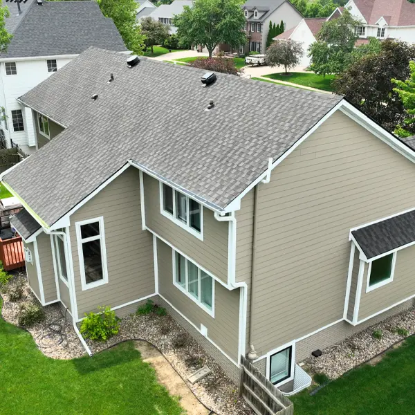 Aerial view of an aging asphalt shingle roof on an Iowa home showing typical wear over time