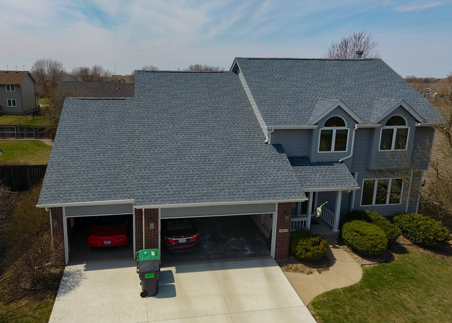 Aerial view of an Andrew's Roofing Company crew installing a new shingle roof on a home.
