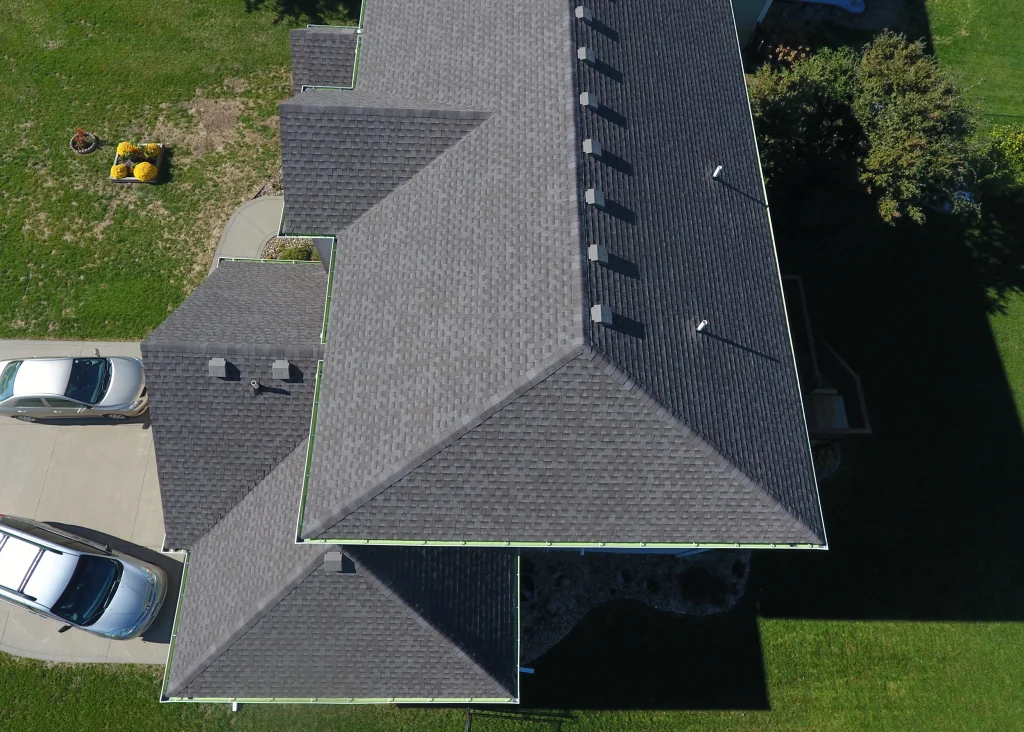 Aerial view of an Andrew's Roofing Company crew installing a new shingle roof on a home.